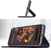 A smartphone case is shown in two configurations: standing up and lying flat with the phone inside. Produktbild-Vorschau