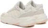 A pair of white Adidas Ozelle women's sports shoes are shown from a rear-side angle against a white background. Náhled obrázku produktu