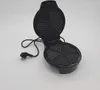 An open black heart-shaped waffle maker with its cord and plug visible, set against a plain white background. Náhled obrázku produktu