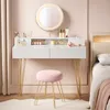A vanity table with a mirror and stool in a bedroom setting. Produktbild-Vorschau