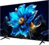 A close-up view of a television screen displaying a vibrant blue flower with golden accents, set against a dark, abstract background with rocky elements. Produktbild-Vorschau
