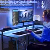 A person is using a gaming desk with dual monitors and RGB lighting. Produktbild-Vorschau