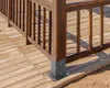 A close-up view of a wooden deck railing post with a metal base. Náhled obrázku produktu