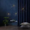A dark blue room with a fern plant, a side table with books, and three "firework" LED lights. Produktbild-Vorschau