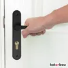A hand is shown turning a black door handle on a white door. Podgląd zdjęcia produktu