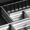 A close-up view of the interior structure of a tool case, showing aluminum rails and black plastic components. Náhľad obrázku produktu