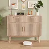 A wooden sideboard with drawers and cabinets is shown in a room with artwork and a plant. Podgląd zdjęcia produktu