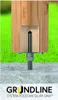 Close-up of a wooden post anchored to a concrete base with a metal bolt and nuts, with a grassy background. Produktbild-Vorschau