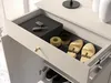 A drawer of a piece of furniture, likely a shoe cabinet, is open, showing various items inside. Podgląd zdjęcia produktu
