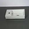 A white ceramic sink is shown on a dark gray surface against a white background. Podgląd zdjęcia produktu