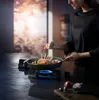 A person is cooking a rack of lamb in a pan on a stovetop. Náhľad obrázku produktu