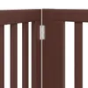 A close-up view of a brown wooden dog gate, showing the hinge mechanism connecting two sections. Produktbild-Vorschau