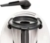 A close-up view of a kitchen appliance accessory, specifically a steam diverter, positioned above the appliance's main unit. Podgląd zdjęcia produktu