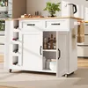 A white kitchen island with a wooden countertop, featuring wine racks, drawers, and cabinets. It is placed on a light-colored rug in a kitchen setting.