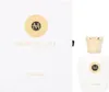 A white perfume box and a white perfume bottle with a gold cap, both featuring the brand's logo. Anteprima dell’immagine prodotto