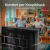 An elderly couple is relaxing in their living room, with the woman using a remote control to operate a TV wall mount. The TV mount is shown in the foreground, attached to a large television. Voir les images du produit