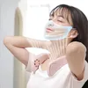 A woman wearing a neck fan and a simulated cooling mask. Produktbild-Vorschau