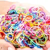 Hands holding a pile of colorful rubber bands. Podgląd zdjęcia produktu