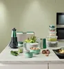 A collection of kitchenware, including a salad spinner, storage containers, and utensils, arranged on a countertop. Produktbild-Vorschau