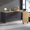 A modern L-shaped desk and sideboard combination with a laptop and decorative items on top, set against a grey wall and large window. Náhľad obrázku produktu