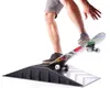 A person is using a skateboard on a mini ramp. Voir les images du produit