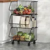 A three-tiered rolling kitchen cart filled with fruits and vegetables, placed on a kitchen floor.