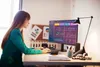 A woman is working on a computer in an office setting. Náhľad obrázku produktu