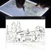 A person's hands are shown using a light box for drawing, with a finished sketch below. Produktbild-Vorschau