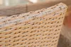 A close-up view of the woven texture of a rattan chair. Náhled obrázku produktu