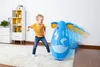 A young girl is playing with an inflatable elephant toy in a room. Produktbild-Vorschau