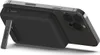 A black Belkin power bank with a kickstand attached to the back of a dark-colored smartphone. Produktbild-Vorschau