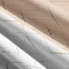 Close-up view of folded fabric with a striped pattern. Produktbild-Vorschau