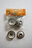 A package of four small, fluted baking molds for cakes, with two molds inside the packaging and two placed below it. Produktbild-Vorschau