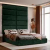 A bedroom scene with a large upholstered headboard and bed. Podgląd zdjęcia produktu