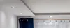 A close-up view of a modern ceiling with recessed LED lights and a section of curtains. Anteprima dell’immagine prodotto