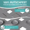 Close-up view of a textured gray shower mat, showing both the top and bottom surfaces with descriptive text overlays. Produktbild-Vorschau