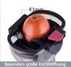 A close-up view of a slow juicer's feeding chute with a tomato inside, highlighting its large opening. Produktbild-Vorschau