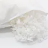 A close-up view of pillow filling spilling out of a white pillowcase. Produktbild-Vorschau