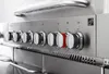 A close-up view of the control panel of a gas grill, showing multiple knobs. Podgląd zdjęcia produktu