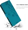 A teal phone case with a floral pattern is shown in a dynamic pose, appearing to fall and break through a white surface, illustrating its drop protection feature. Náhled obrázku produktu