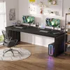 A modern gaming desk setup with two computer monitors, keyboards, headphones, and a gaming PC. Produktbild-Vorschau