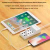 A white USB charging station with multiple ports is shown on a wooden surface, charging a tablet and a smartphone. Náhled obrázku produktu