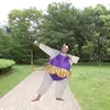 A person in an inflatable costume poses in a park. Náhled obrázku produktu