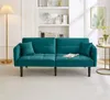 A teal futon sofa is shown in a living room setting with a floor lamp and a side table. Anteprima dell’immagine prodotto
