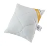 A white quilted pillow with a yellow and white tag on the side. Náhľad obrázku produktu