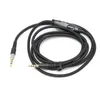 A black audio cable with 3.5mm connectors and an in-line volume control, laid out on a white background. Náhľad obrázku produktu