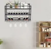 A black metal wine rack with bottles and glasses mounted on a light gray wall, next to a wooden bookshelf. Náhled obrázku produktu