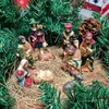 A nativity scene with figurines arranged among pine branches and straw. Produktbild-Vorschau