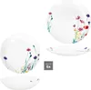 A collection of white plates and bowls decorated with delicate floral patterns. Produktbild-Vorschau