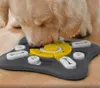 A dog interacting with a puzzle feeder toy. Produktbild-Vorschau